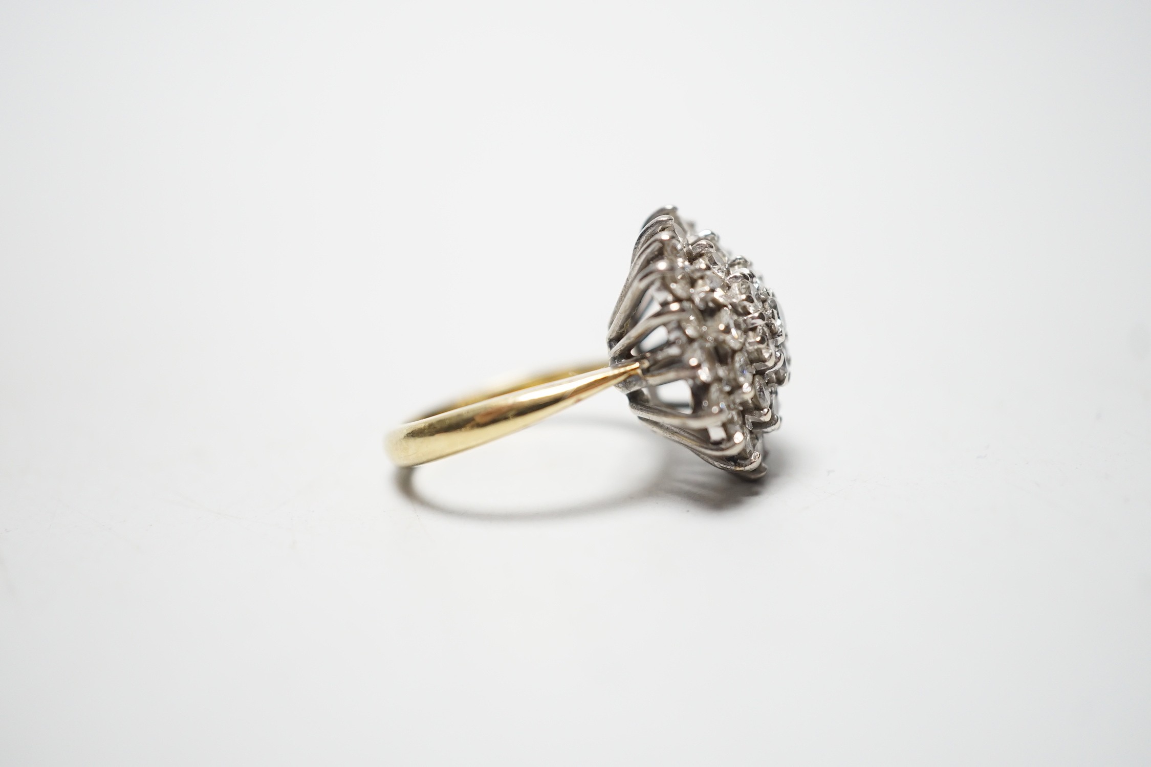 A modern 18ct and diamond set circular cluster ring, size I/J, gross 7.9 grams.